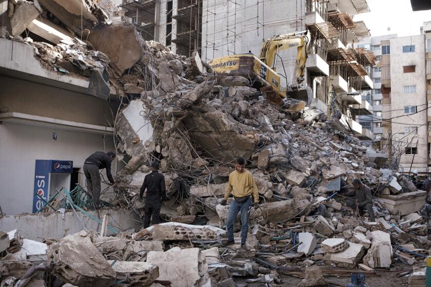 Workers clear debris following an Israeli airstrike that targeted a Syrian Baath Party building in the Ras el Nabaa neighborhood on November 17, 2024, in Beirut, Lebanon. The strike resulted in seven fatalities, including Mohammad Afif, Hezbollah's media officer, and injured 16 others, according to the final report from the Ministry of Health. Photo by Basili Sandro/Abaca/Sipa USA(Sipa via AP Images)