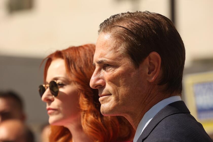 Los Angeles, CA - October 09: District Attorney Candidate Nathan Hochman and Actress Esme Bianco prepare to speak during a press conference to criticize L.A. County D.A. George Gascon for failing to prosecute the singer Marilyn Manson, and mishandling scores of other cases involving gender-based violence on Wednesday, Oct. 9, 2024 in Los Angeles, CA. (Michael Blackshire / Los Angeles Times)