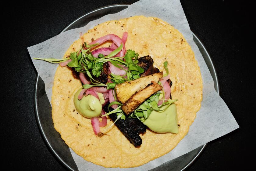 An overhead of a black-octopus taco at Evil Cooks' new El Sereno restaurant