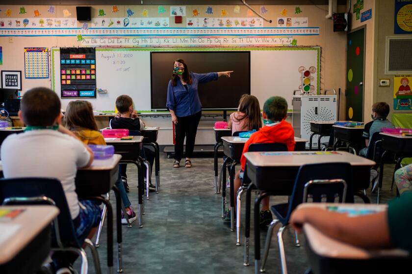 WEAVERVILLE, CA - AUGUST 17: Darsi Green speaks to students in her second grade glass at Weaverville Elementary School on the first day on returning to in-person instruction on Monday, Aug. 17, 2020 in Weaverville, CA. The Trinity Alps Unified School District reopened amid the coronavirus pandemic, resuming in-person classroom instruction. (Kent Nishimura / Los Angeles Times)