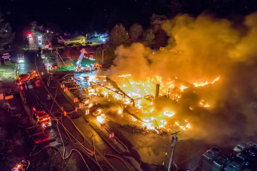 During filming for an HBO mini-series, a fire destroyed a former Ellenville, N.Y., auto dealership that was being used as a set for an HBO mini-series, "I Know this Much is True," starring Mark Ruffalo. The May 2019 fire divided the small village, incinerated prop cars and badly damaged mobile homes on the periphery of the property. The families living in those homes have been waiting for HBO to compensate them for the destruction. (Chris Ramirez / Firehouse Road)