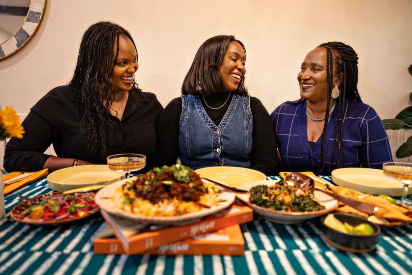 Los Angeles, CA - November 02: Culinary producer, personality and cookbook author Kiano Moju make a Swahili chicken biriyani and sukuma wiki (collard greens) and samosas with her mom, Katano Kasaine and Aunt Juliet Solitei on Saturday, Nov. 2, 2024 in Los Angeles, CA. (Jason Armond / Los Angeles Times)