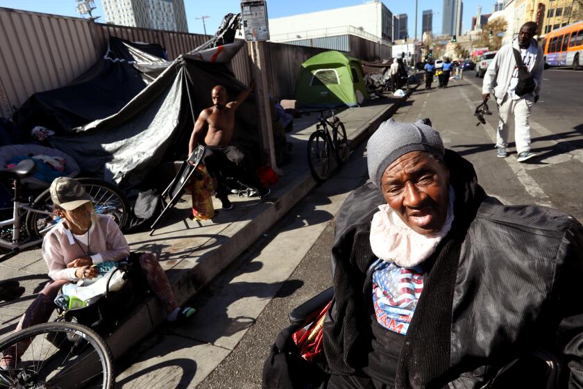 LOS ANGELES, CA - NOVEMBER 20, 2024 - - "They already have us in tents," said Gwendolyn Shine, 69, right, responding to President-elect Trumps promise regarding the homeless, and has been living homeless on the streets of Skid Row in Los Angeles on November 20, 2024. "We're not criminals," said Keith Aaron Robinson, 44, second from left, who has been living in Skid Row for over 5 years. President-elect Donald Trump has promised to arrest thousands of homeless people sleeping in American streets and move them to large tent cities on "inexpensive land," one of several planks of his agenda that would upend a national strategy that focuses on finding people housing on a voluntary basis. (Genaro Molina/Los Angeles Times)