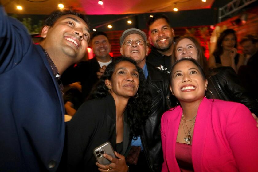 LOS ANGELES, CA - NOVEMBER 5, 2024 - - Ysabel Jurado, lower right, running for Los Angeles City Council District 14, poses for a selfie with Los Angeles City Council Member Nithya Raman, former L.A. City Council Member Mike Bonin, in cap, Los Angeles City Council Member Hugo Soto-Martinez, background, and others at her Election Night Party at Block Party Highland Park on November 5, 2024. (Genaro Molina/Los Angeles Times)