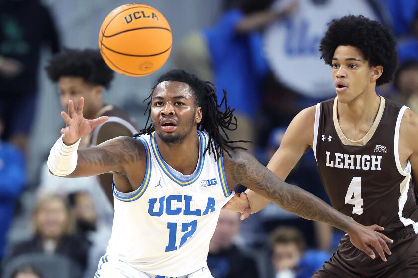 Los Angeles, California November 15, 2024-UCLA''s Sebastian Mack receives a pass in front of Lehigh's Joshua Ingram at Pauley Pavilion Friday. (Wally Skalij/Los Angeles Times)