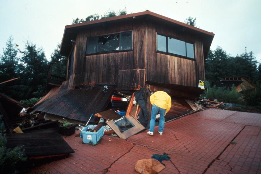 A home collapses in the Boulder Creek area of the Santa Cruz Mountains during the magnitude 6.9 Loma Prieta earthquake of 1989.