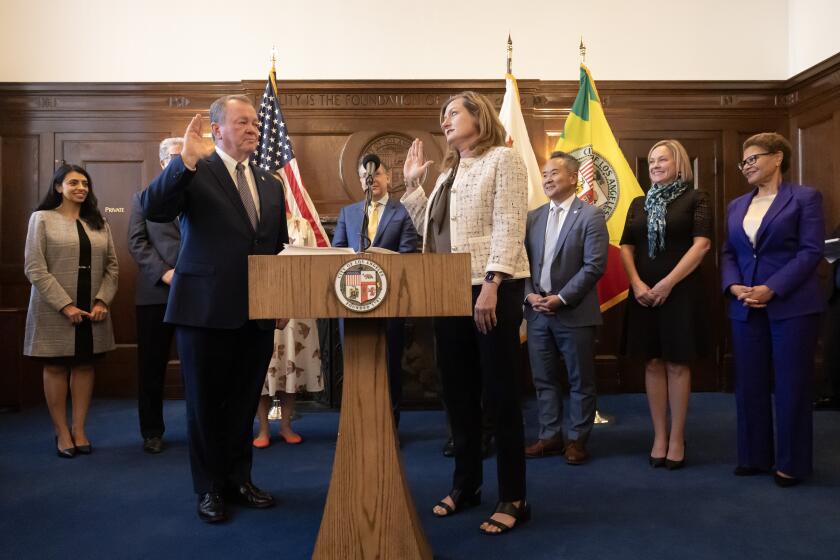 LOS ANGELES, CA - NOVEMBER 08: Jim McDonnell is sworn in by Los Angeles City Clerk Holly Wolcott as the new police chief of Los Angeles at City Hall on Friday, Nov. 8, 2024. (Myung J. Chun / Los Angeles Times)