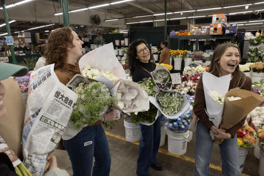 LOS ANGELES, CA - NOVEMBER 08: Emily Marriott, right, is getting married the next day and was out flower shopping with her mother Rebecca, center; sister-in-law Kellie Hastings and not shown, sister Sarah Marriott and fiance David Cohen at The Original Los Angeles Flower Market in Los Angeles, CA on Friday, Nov. 8, 2024. (Myung J. Chun / Los Angeles Times)