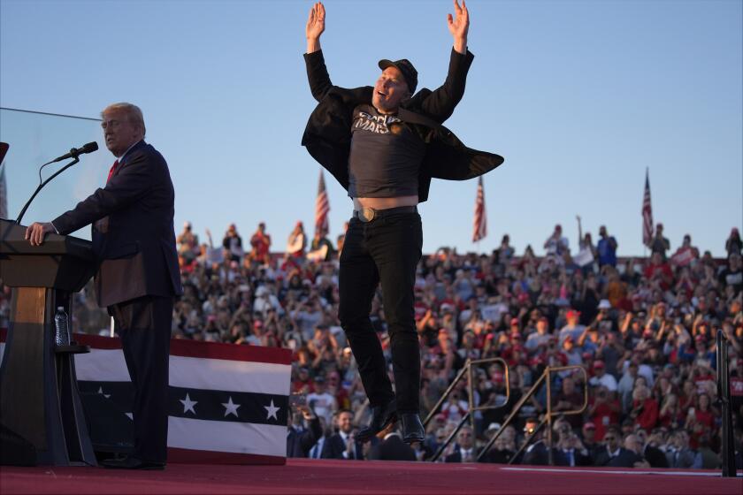 Elon Musk salta en el escenario mientras el candidato presidencial republicano y expresidente, Donald Trump, habla en un mitin de campaña en la Feria Agrícola de Butler, el sábado 5 de octubre de 2024, en Butler, Pensilvania. (AP Photo/Evan Vucci)