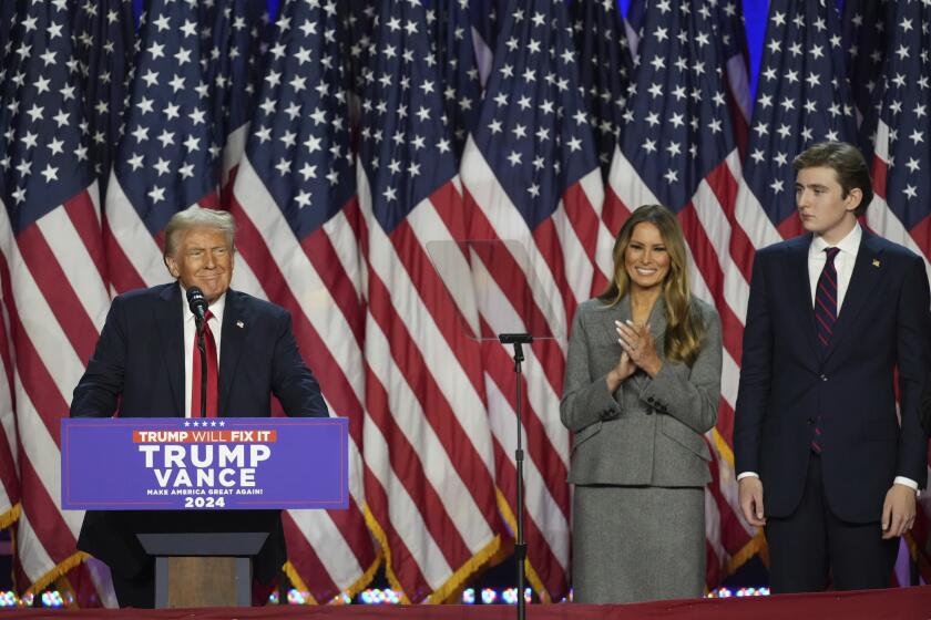 Republican Presidential nominee former President Donald Trump, joined by former first lady Melania Trump and son Barron Trump, speaks at the Palm Beach County Convention Center during an election night watch party, Wednesday, Nov. 6, 2024, in West Palm Beach, Fla. (AP Photo/Lynne Sladky)