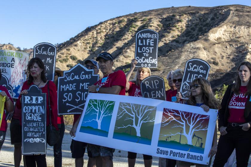 PORTER RANCH, CALIF. -- WEDNESDAY, OCTOBER 23, 2019: North San Fernando Valley residents hold a rally near the entrance of SoCal Gas company’s Alison Canyon storage facility marking the fourth anniversary of the Aliso Canyon gas blowout in Porter Ranch, Calif., on Oct. 23, 2019. (Brian van der Brug / Los Angeles Times)