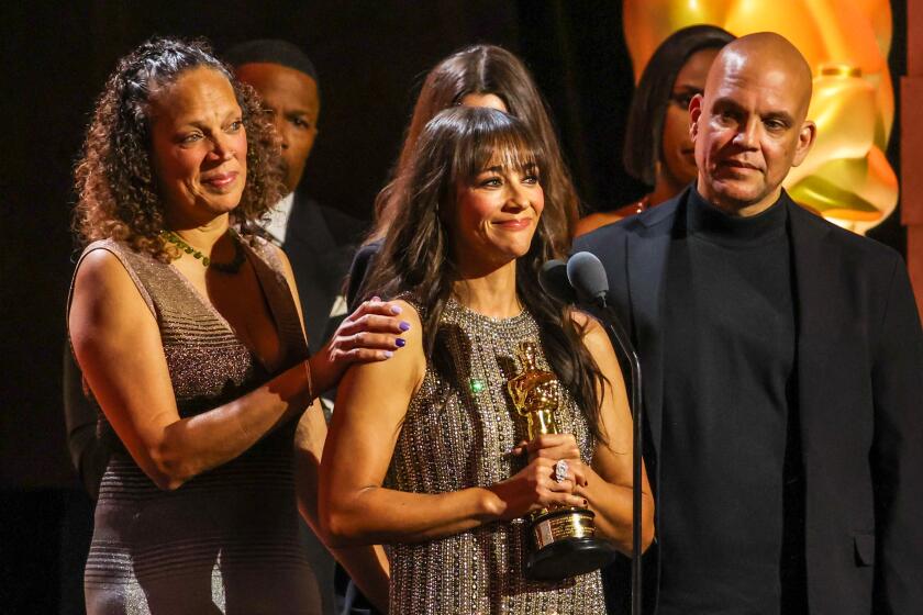 Rashida Jones accepts an honorary Oscar for late father Quincy Jones at the Governor's Awards.