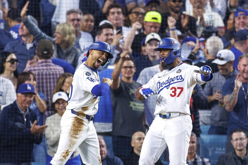 Dodger Teoscar Hernández celebrates with teammate Mookie Betts after hitting a two-run homer during the World Series