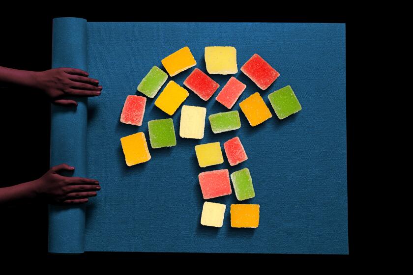 photo illustration of a blue yoga mat on a black background with gummy candies in the shape of a mushroom