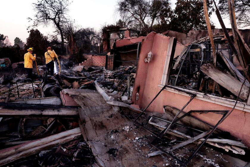 Camarillo, California November 7, 2024-Firefighters put out hot spots at a home that burned to the ground rom the Mountain Fire in Camarillo. (Wally Skalij/Los Angeles Times)