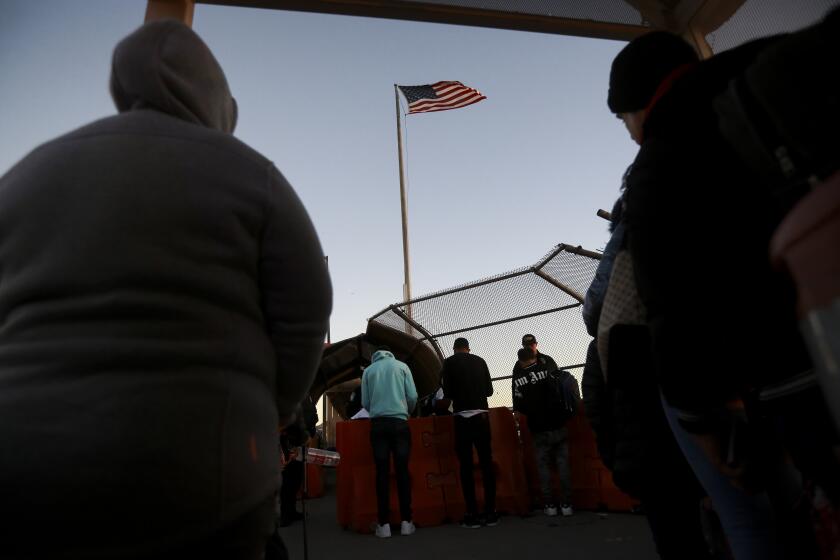 Migrants line up to present to U.S. agents documents requesting an appointment to apply for asylum at the Paso del Norte international bridge, in Ciudad Juarez, Mexico, Tuesday, Nov 5, 2024. (AP Photo/Christian Chavez)