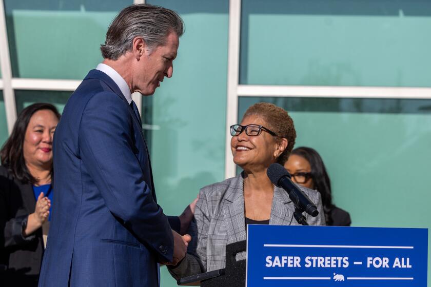 Los Angeles, CA - October 29: Los Angeles Mayor Karen Bass, right, joins California Governor Gavin Newsom, left, at a press conference at the Downtown Women's Center to announce new state funding to confront the homelessness crisis in Los Angeles by bringing Angelenos off the streets and into housing with comprehensive services on Tuesday, Oct. 29, 2024 in Los Angeles, CA. (Brian van der Brug / Los Angeles Times)