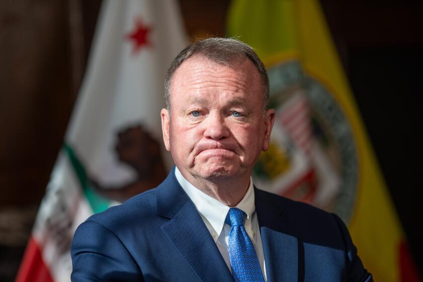 Los Angeles, CA - October 04: Jim McDonnell (R) speaks after being introduced by Mayor Karen Bass to serve as the new Chief LAPD during a press conference at City Hall Friday, Oct. 4, 2024 in Los Angeles, CA. (Ringo Chiu / For The Times)