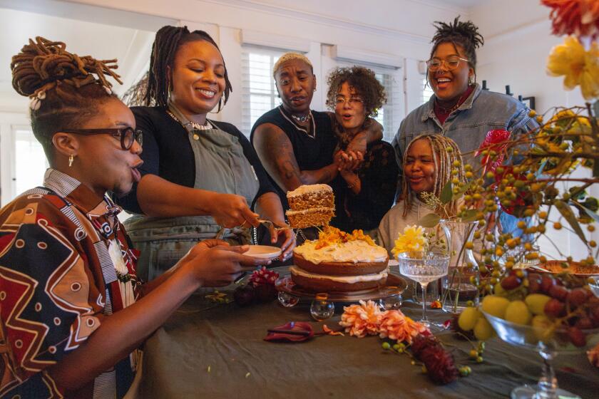 Los Angeles, CA - October 26: Nia Lee serves her carrot cake at her friends-giving dinner on Saturday, Oct. 26, 2024 in Los Angeles, CA. (Jason Armond / Los Angeles Times)