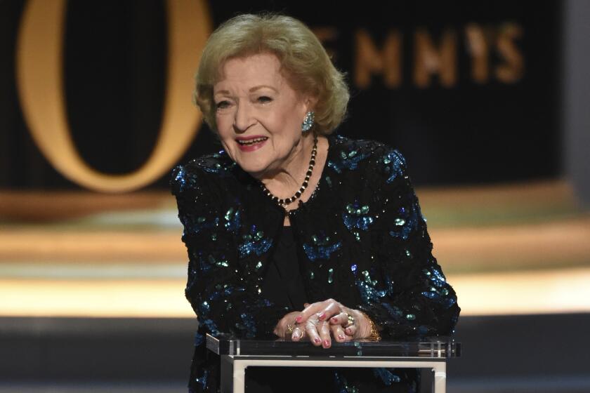 Betty White, in a black and blue sequined ensemble, speaks on stage at the 2018 Primetime Emmy Awards in Los Angeles