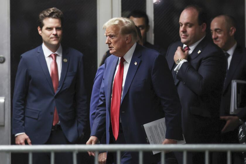 Former President Donald Trump, center, walks by Rep. Matt Gaetz, left, R-Fla., outside the courtroom after the day's proceedings in his trial Thursday, May 16, 2024, in New York. Trump's adviser Boris Epshteyn, and attorney Emil Bove, right, follow behind him. (Mike Segar/Pool Photo via AP)