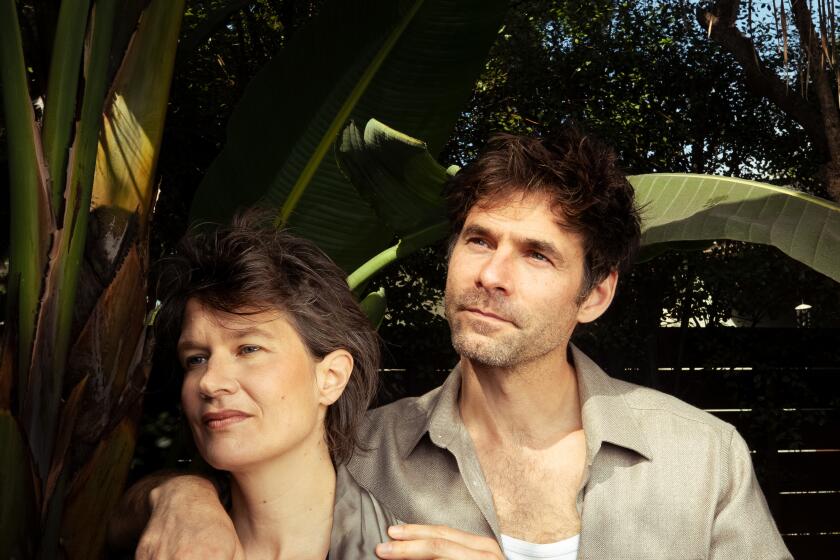 Camille Dalmais and Clement Ducol, stand among the plants looking happy.